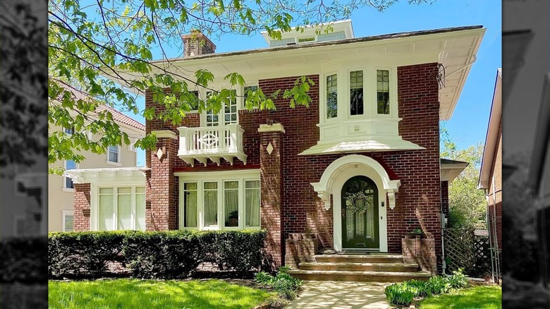 Historic red brick home with white trim and windows.