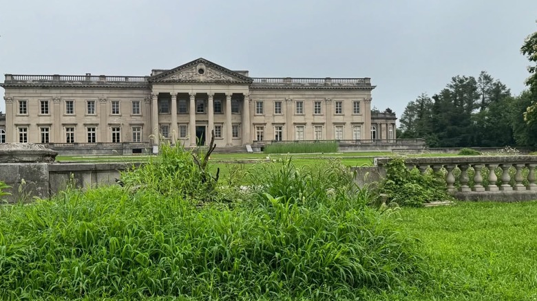 Lynnewood Hall in its present state with overgrown grounds in front