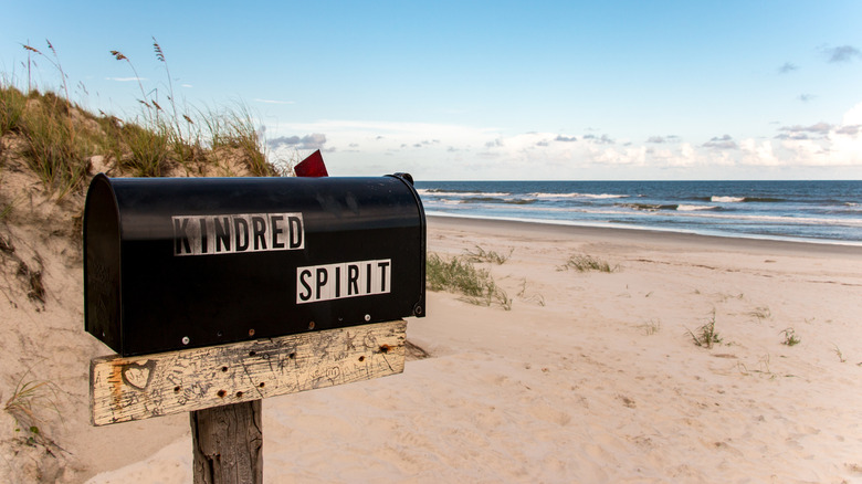 Side view of the Kindred Spirit Mailbox with the beach in the background in North Carolina