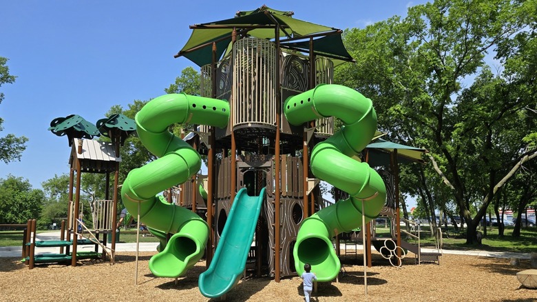 A child walks toward a slide at a giant playground in Natural Springs Park -- Anna, Texas