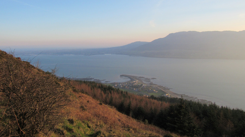 View overlooking a lake and a town with mountains in the background