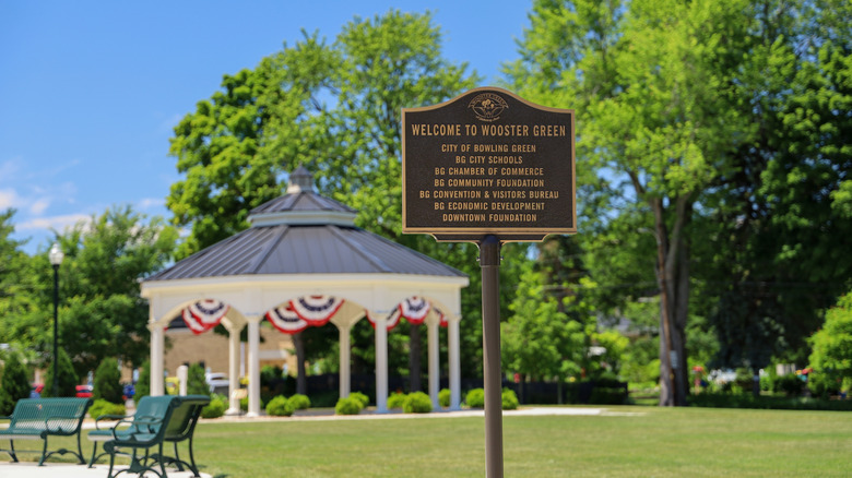 A recognition plaque on a pole by the entrance at Wooster Green Park in Bowling Green, Ohio