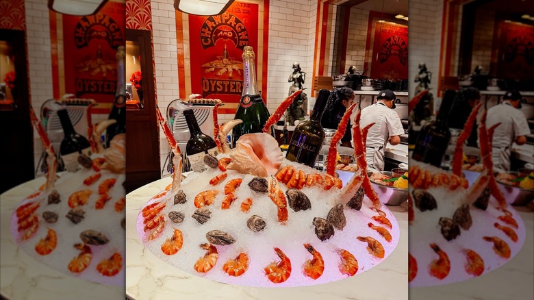 king grab claws with jumbo shrimp and oysters on platter of ice