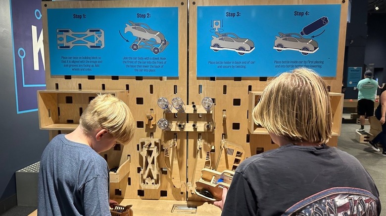 kids working on interactive exhibit with cars at Orlando Science Center