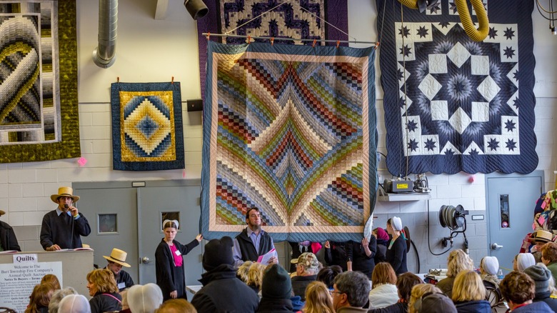 Handmade quilts for sale at an Amish auction