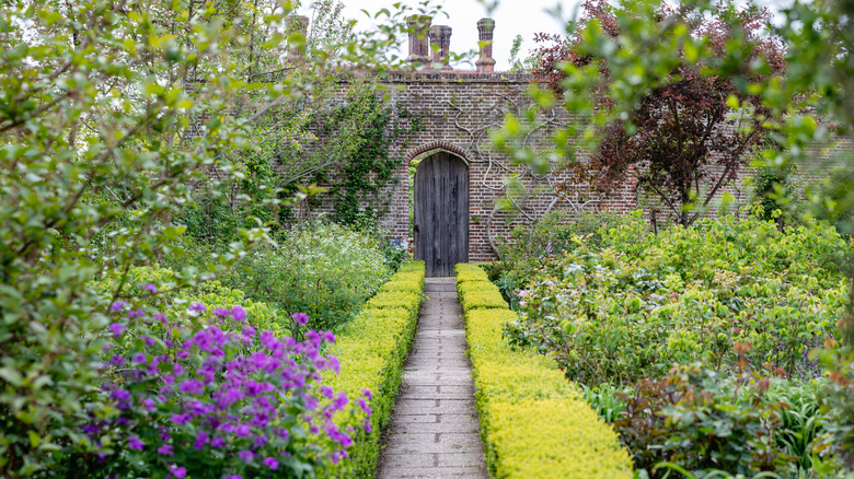 A garden path leading to a brick wall at Sissinghurst Castle, England