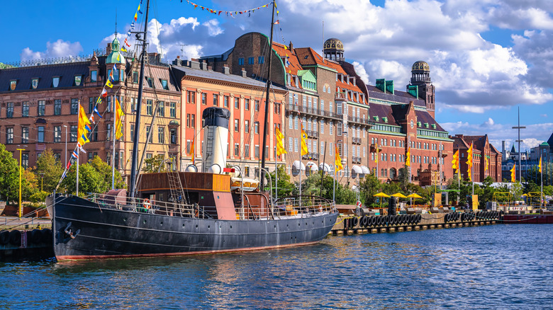 Picturesque canal in the center of Malmo, Sweden, with a historic boat