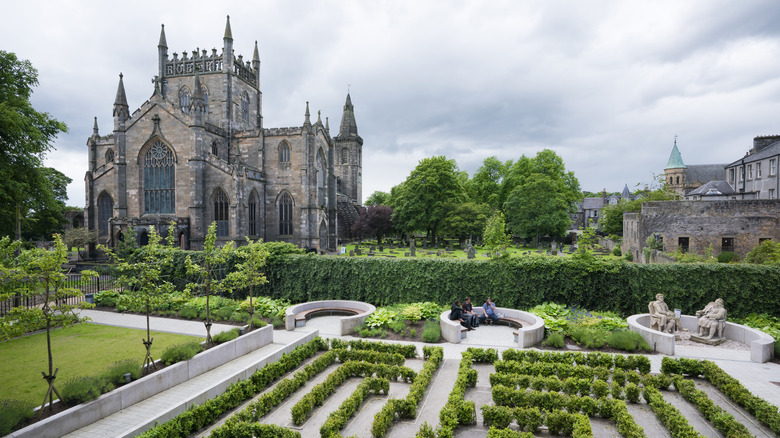 People sitting outside of Dunfermline Abbey and Palace