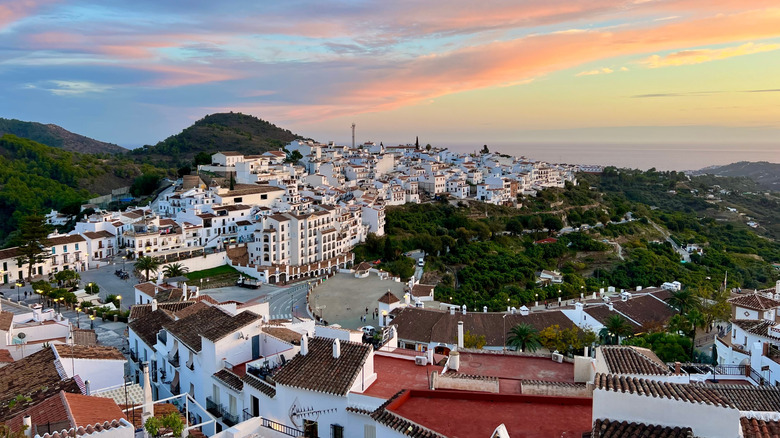 Panoramic view of Frigiliana, Spain, against the sea at sunset