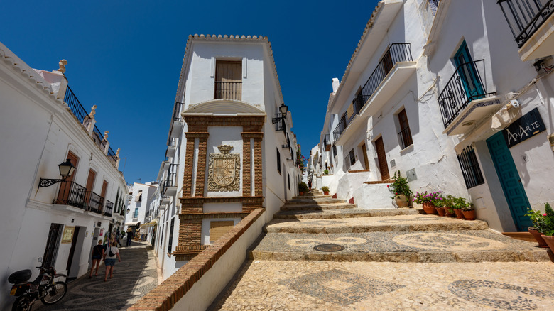 A royal crest on a white building in Frigiliana, Spain