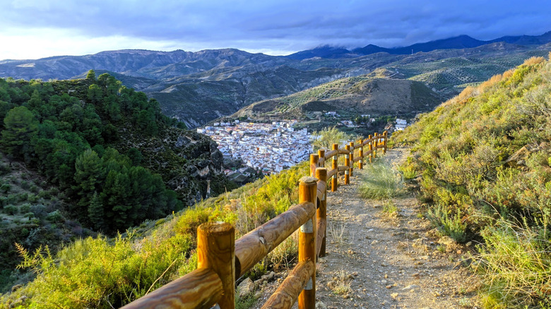 A path along Spain's Sierra Nevada Mountains overlooking a whitewashed town