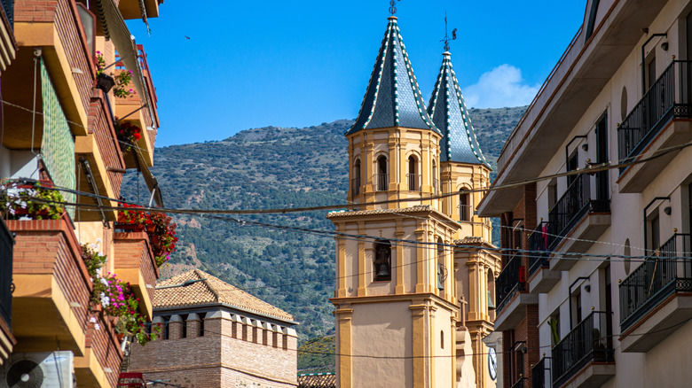 Church towers with mountains in background in Orgiva, Spain