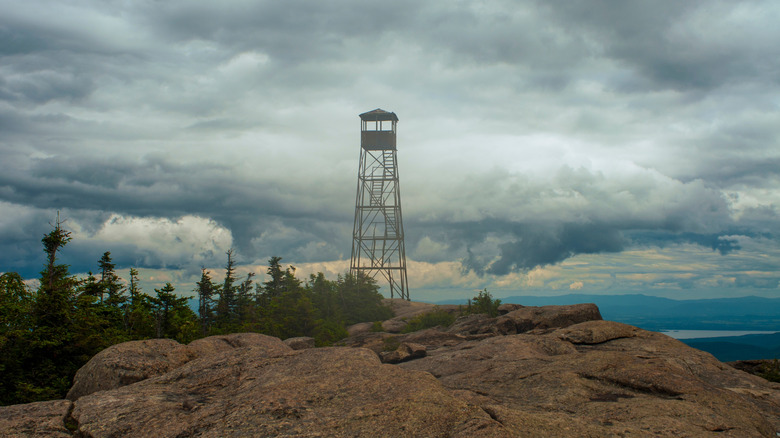 Hurricane Mountain fire tower in front of cloudy sky