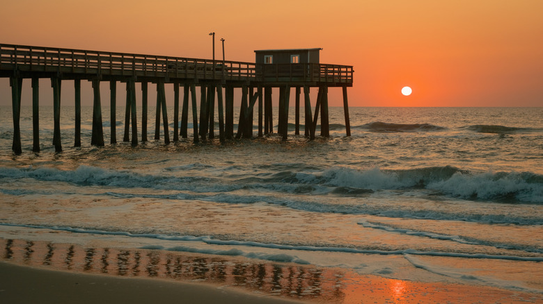 Waves hitting the shore at sunrise at the Avalon Fishing Pier