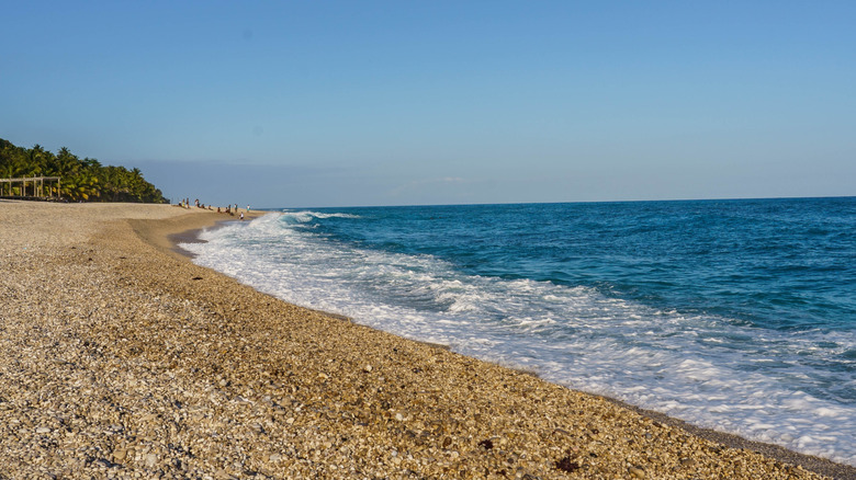 Waves and pebble-lined beach of Playa Los Patos