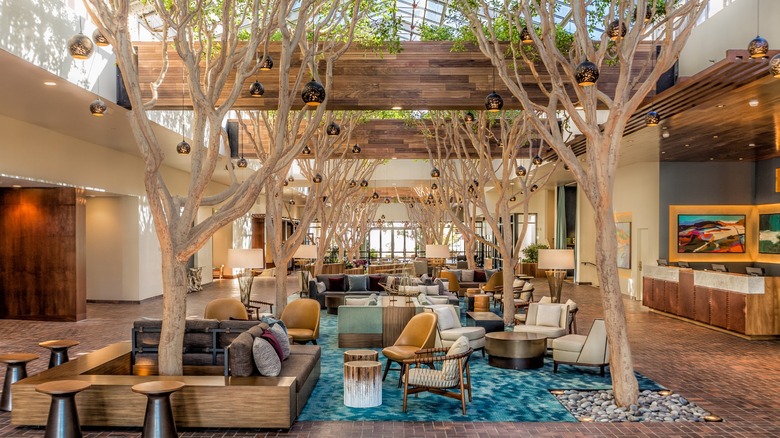Lobby with trees at Portola Hotel & Spa at Monterey Bay