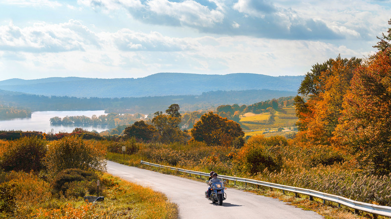 lake waramaug with fall leaves and people riding a motorcycle