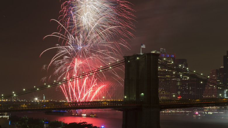 Brooklyn Bridge with fireworks in the East River