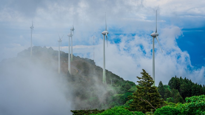 Wind turbines covered by fog on the Escazu Mountains