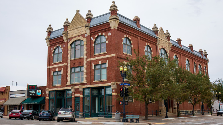 View of McPherson Opera House in Kansas with cars lining the street outside