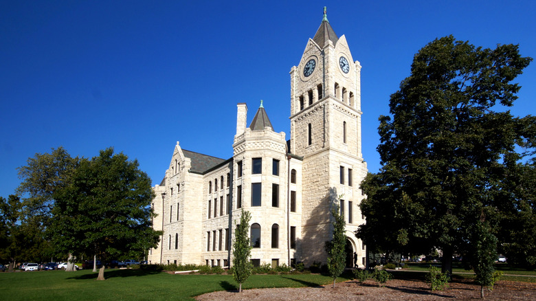 McPherson County District Court in Kansas, on a clear day surrounded by mature trees and lawn