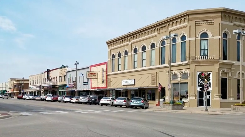 View of storefronts on main street with cars lining the street in McPherson, Kansas