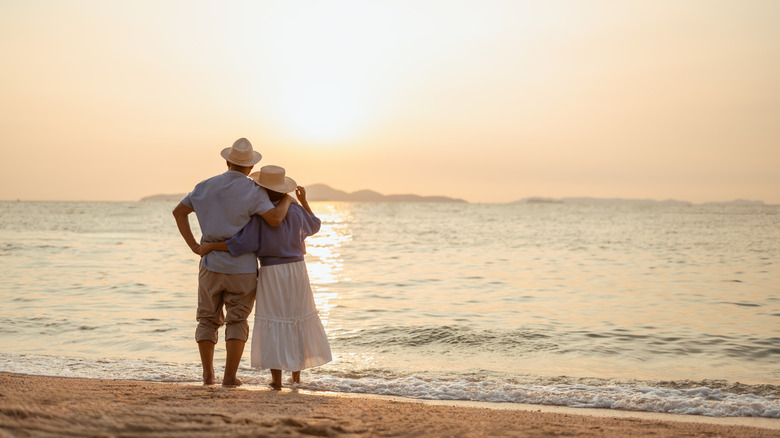 A couple on the beach watching the sunset