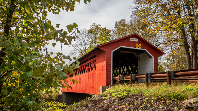 Red covered bridge with early foliage in Central Vermont
