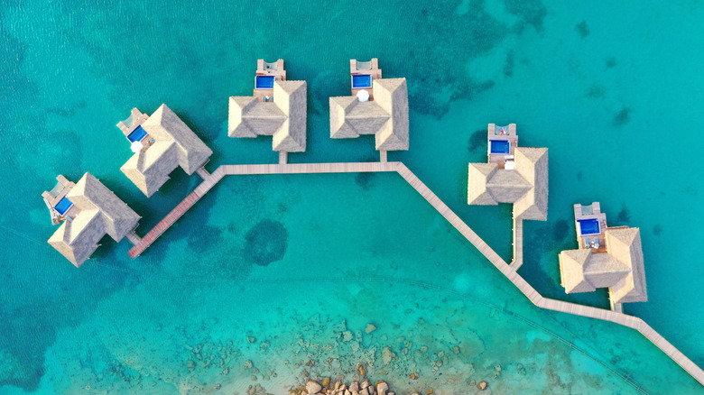 Aerial of the six Chairman Overwater Bungalows at the Royalton Antigua, a five-star resort on Antigua's Deep Bay