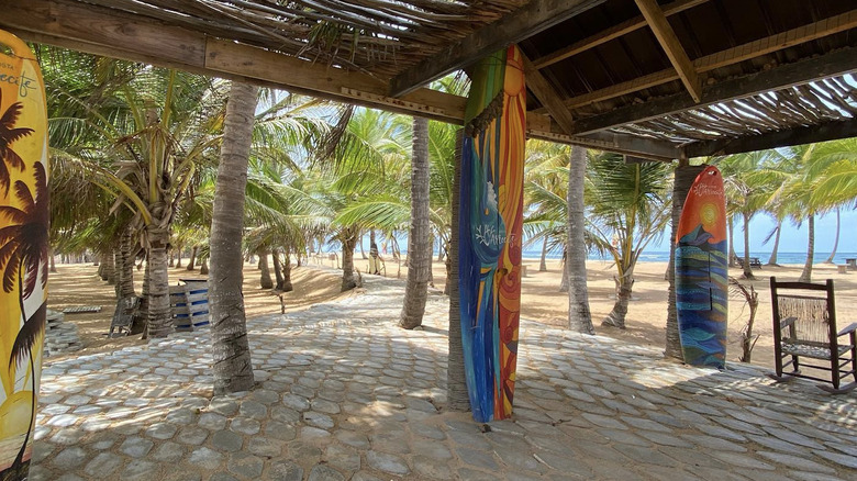 View of La Vacama Beach colorful surfboard decor and covered shelter.