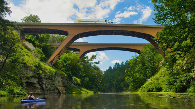 Kayak on Mirror Lake in Wisconsin, two Interstate highway bridges overhead