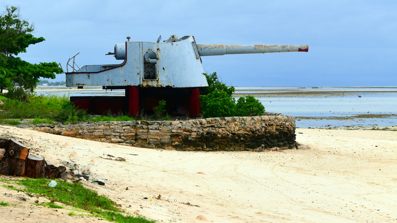 A World War II abandoned artillery gun on a beach in Kiribati