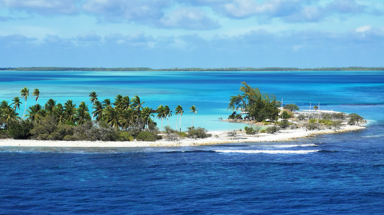 Aerial view of an atoll surrounded by turquoise lagoons in Kiribati
