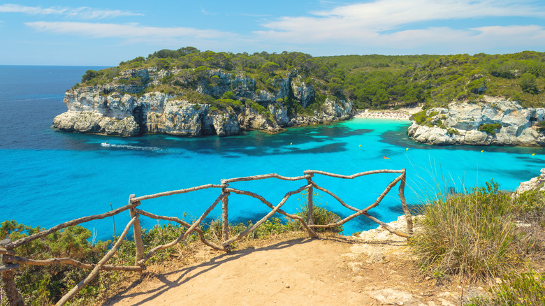 View from a sandy walkway on a cliff over Cala Macarelleta cove in Portugal