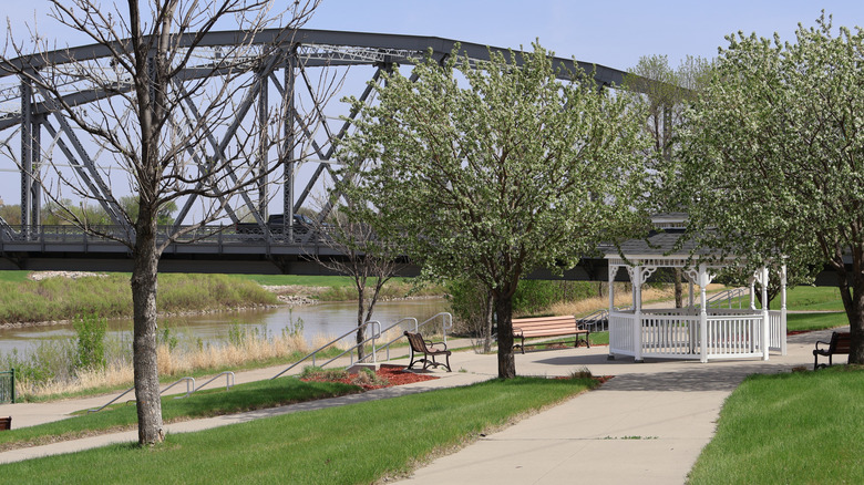Path on the Red River Greenway in Grand Forks, North Dakota, with a bridge in the background