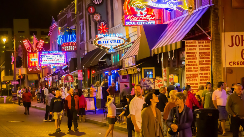 People and neon lights adorn Memphis' Beale Street