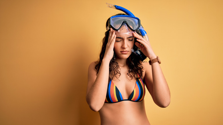 female snorkeler in pain 