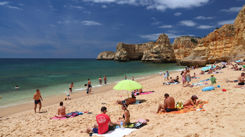 Beach goers on Praia da Marinha, Portugal.