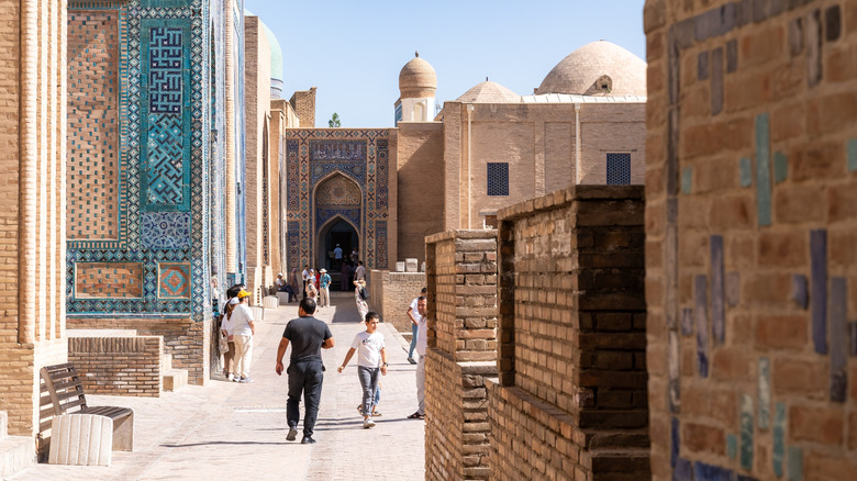 People walking through the streets of the Shah-i Zinda necropolis in Samarkand, Uzbekistan