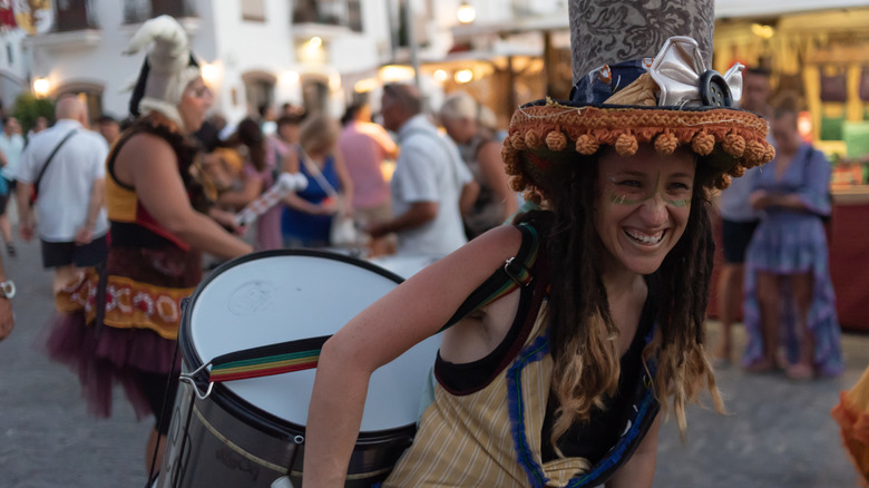 Batucada street performer with big drum at Festival de las Tres Culturas
