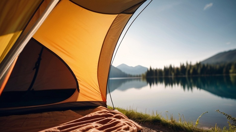 A view of a lake and mountains from inside a tent