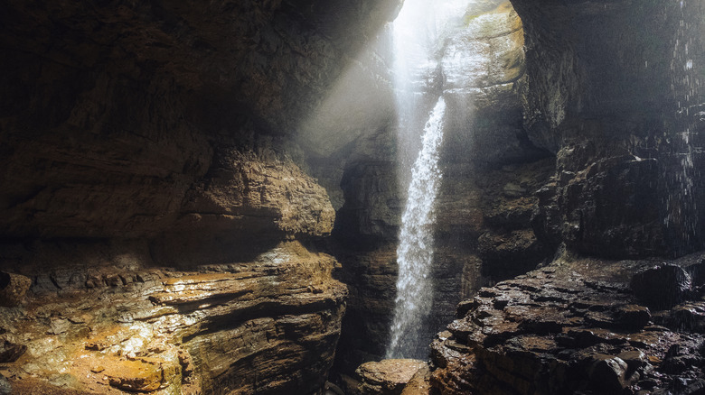 The waterfall in Stephen's Gap surrounded by an expansive cave opening.