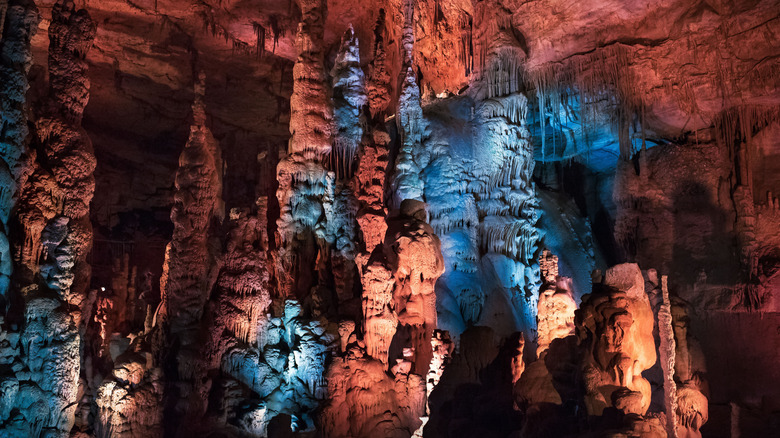 Cave formations at Cathedral Caverns lit up in blue and red light.