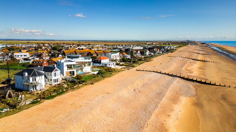 Houses on coastline at golden sandy beach