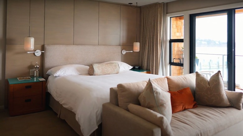 Bed and couch in a guest room at The Inn Above Tide.