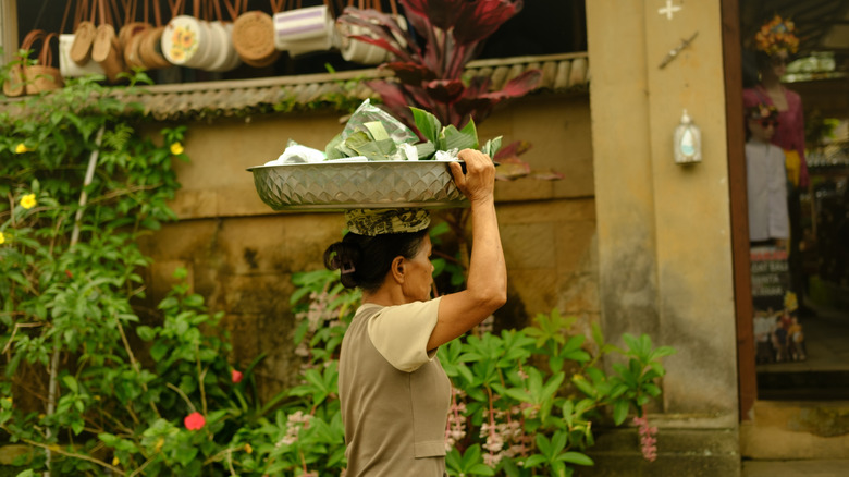 A resident of Penglipuran carrying wares on her head