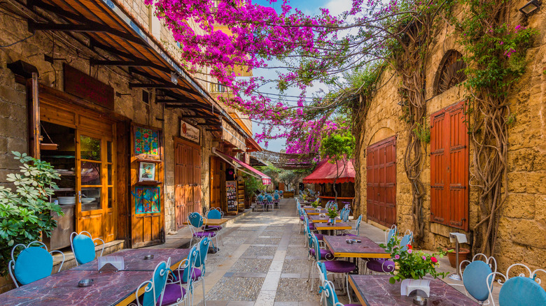 Alleyway with tables and chairs in Old Souk in Byblos, Lebanon
