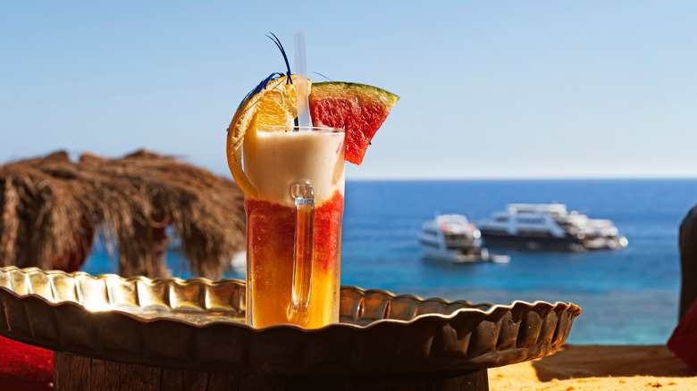Fruit cocktail with slices of fruit in a tropical beach bar