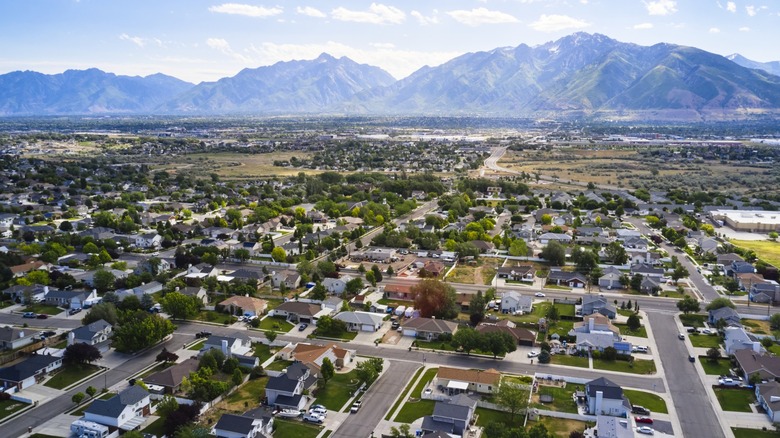 Arial view of a residential community with a mountainous backdrop in Utah