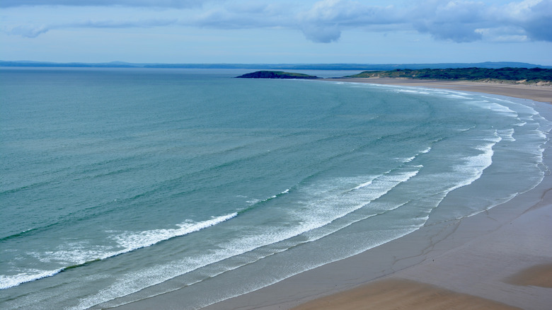 Waves break on the sands of Rhossili and Llangennith beach